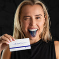 Woman with a blue tongue holding box