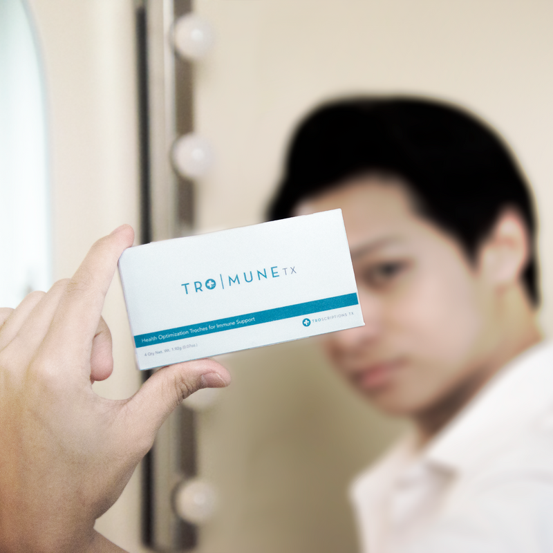 Guy holding tro mune box troscriptions