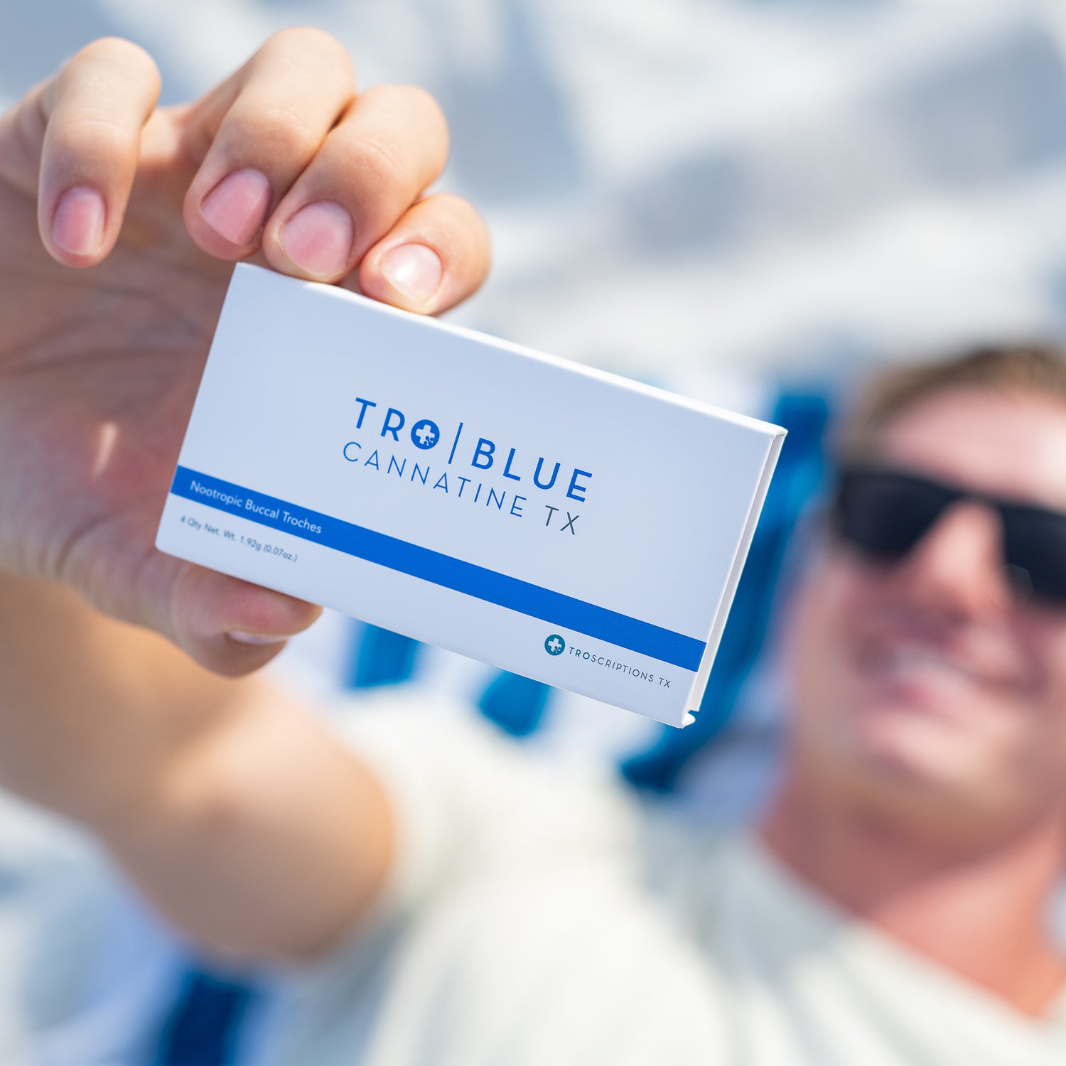 Close up of a Blue Cannatine box being held up