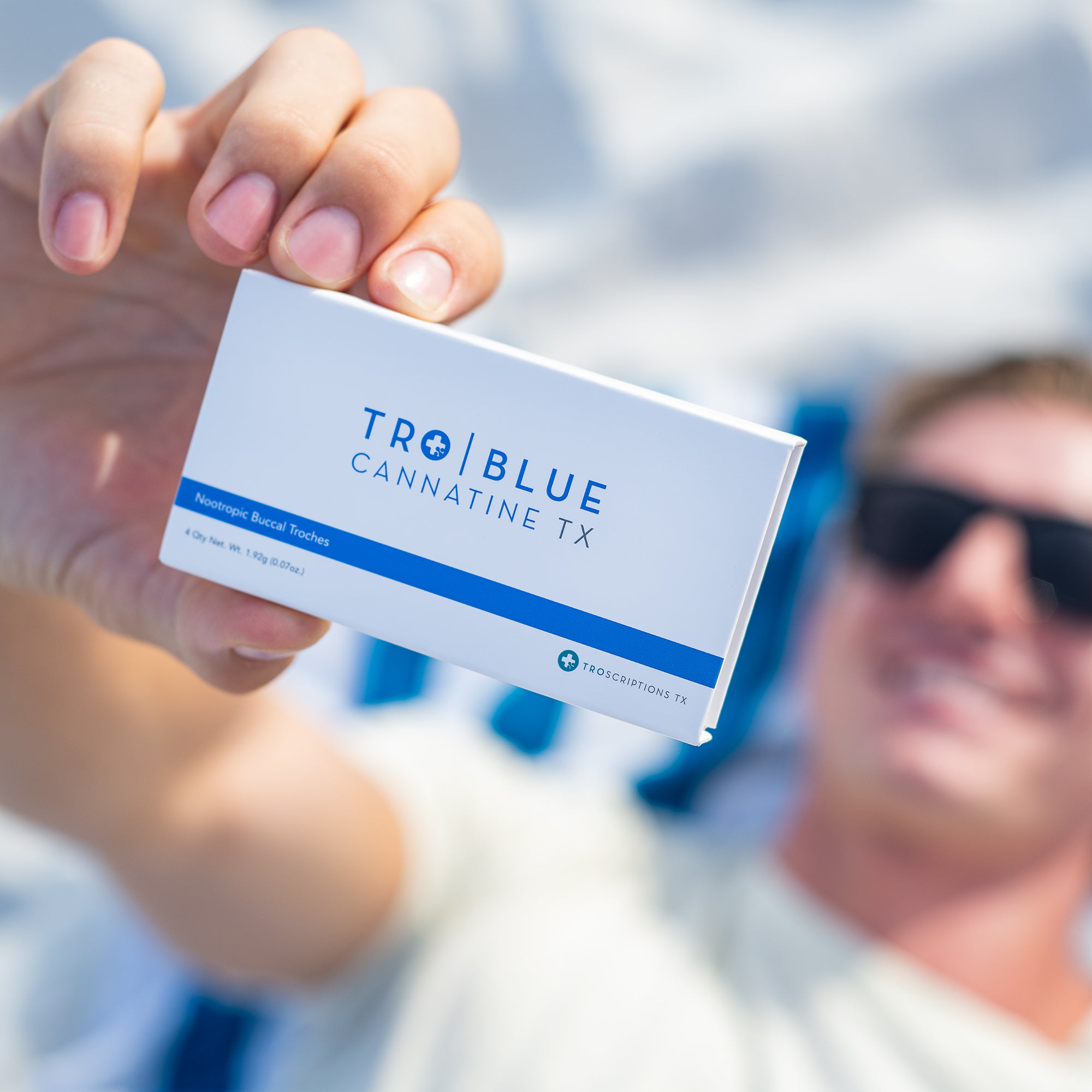 Close up of a Blue Cannatine box being held up