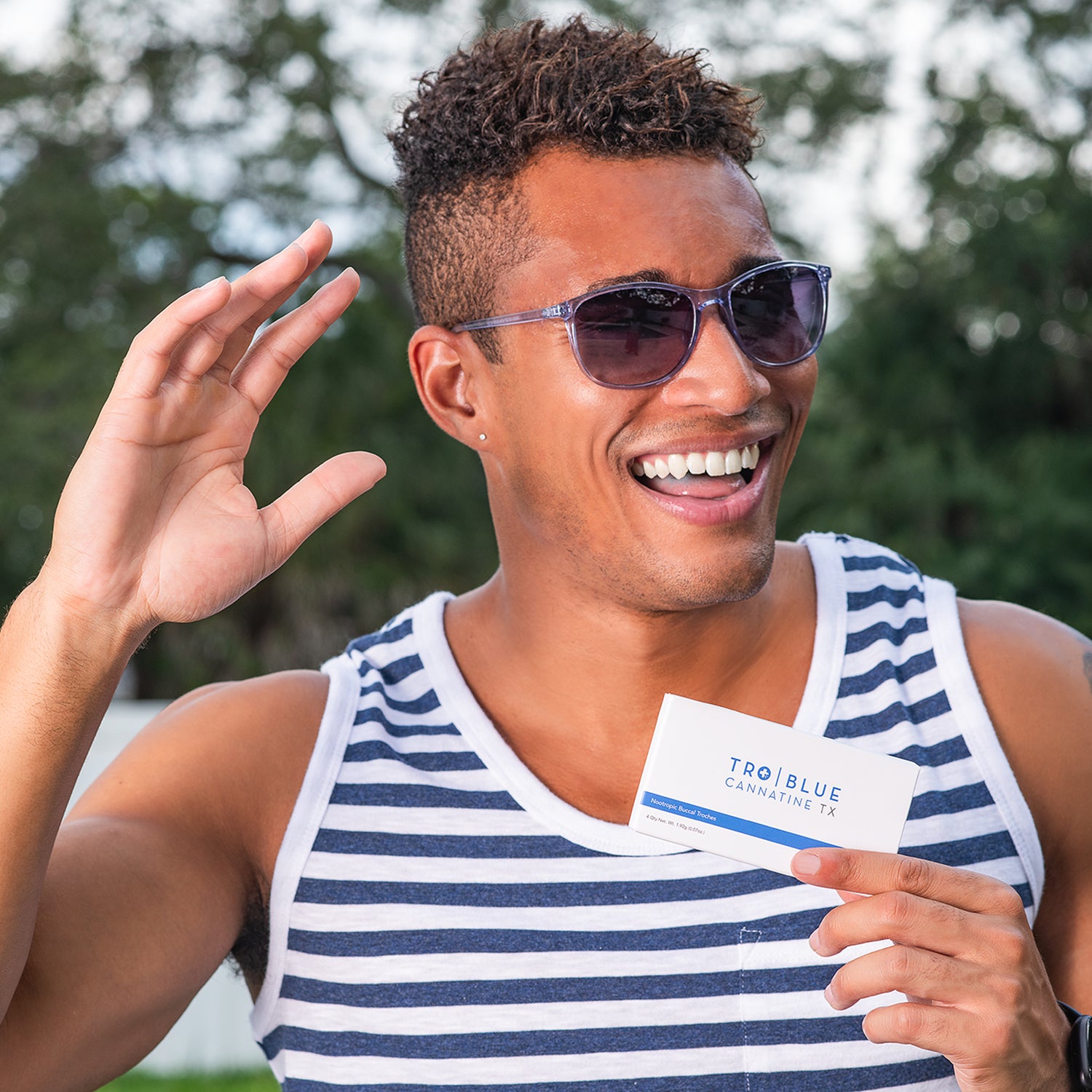 man holding up a box of Blue Cannatine