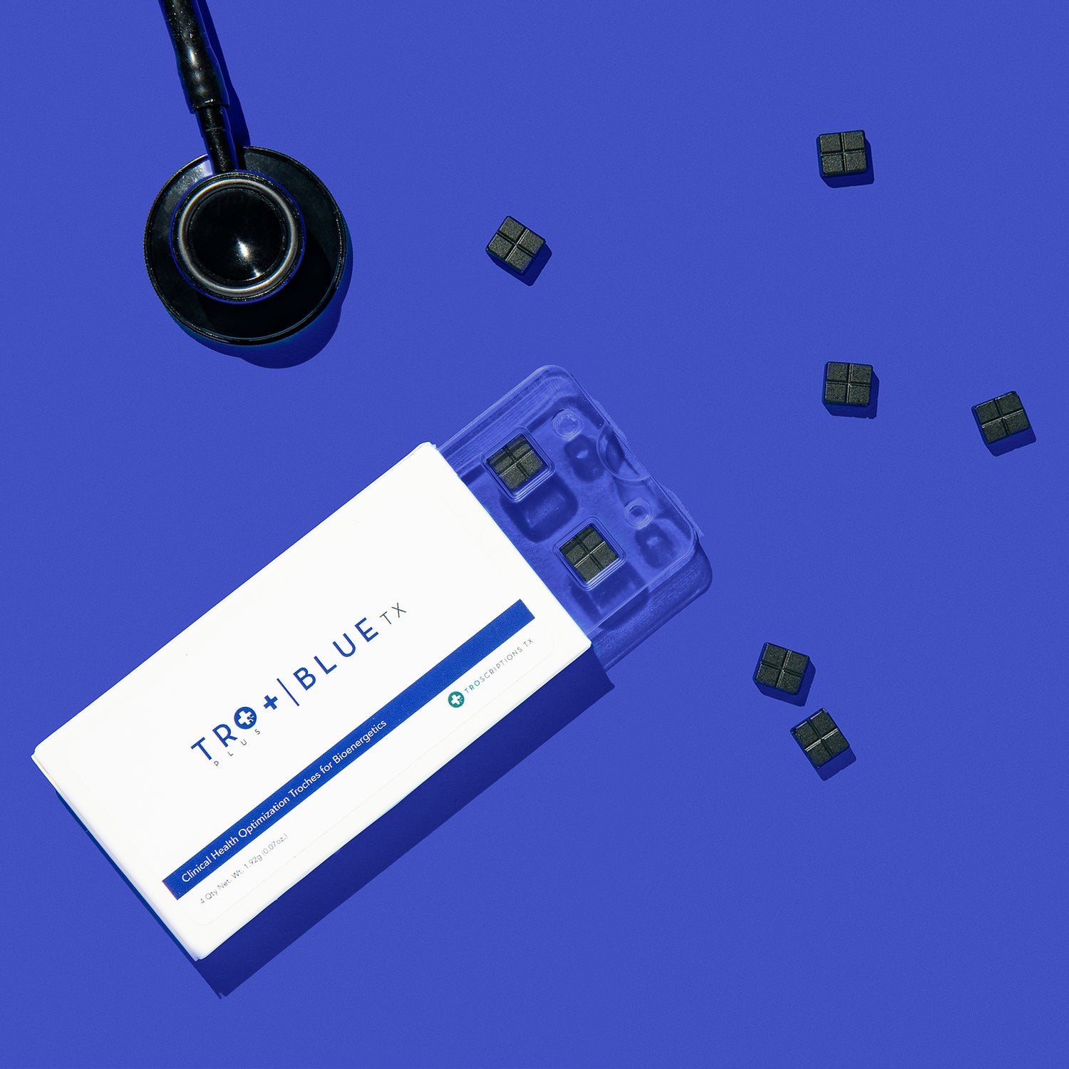 A box of Tro+ Blue and its troches next to a stethoscope