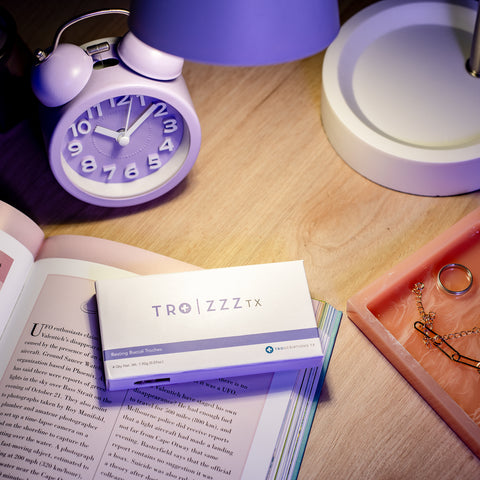 Tro Zzz product portrait with clock and book at night