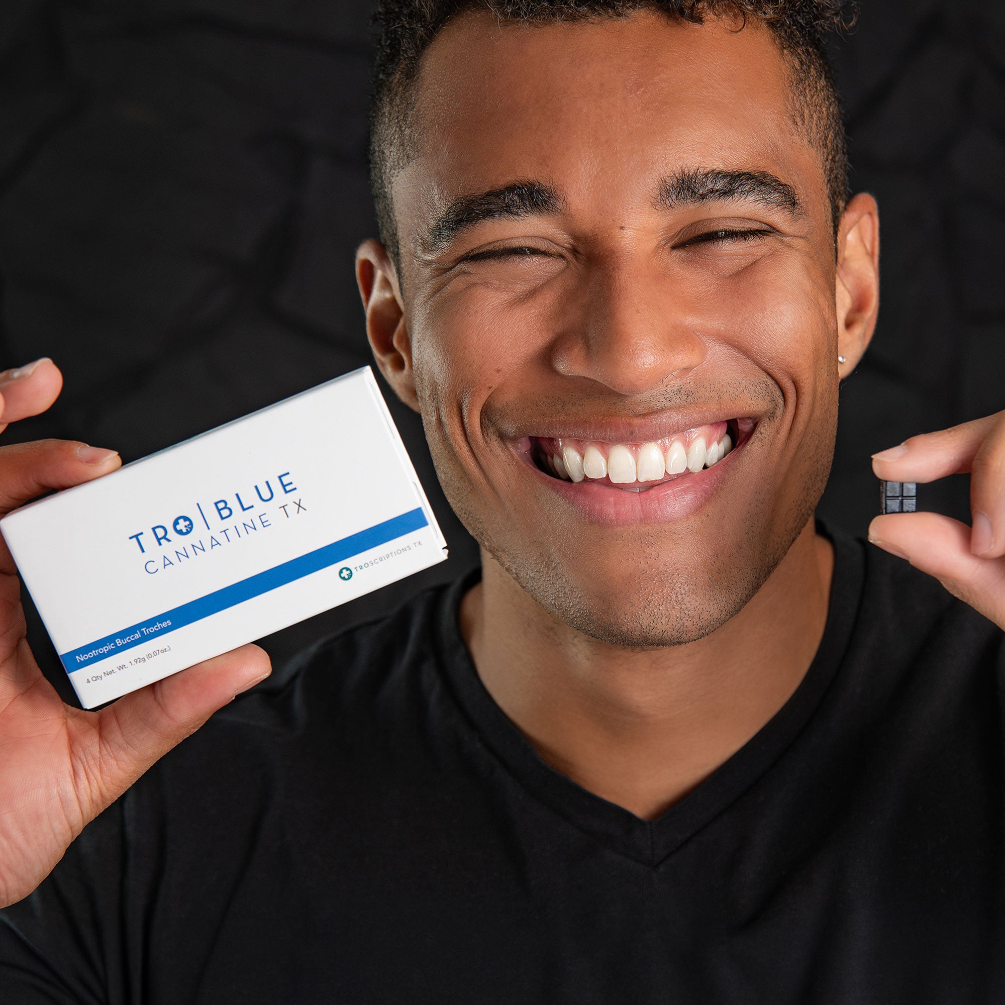 Guy smiling while holding a troche